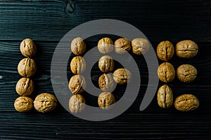 Walnuts are folded into a word of life on a dark wooden table