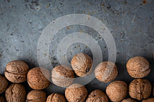 Walnuts on a gray background, metal surface, grunge, overhead, copy space