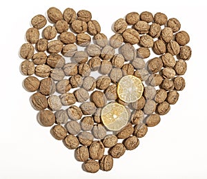 Walnuts heart shaped with two sliced lemons