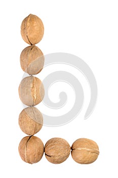 Walnuts lined in the shape of the letter "L" isolated on white