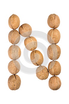 Walnuts lined in the shape of the letter "N" isolated on white