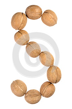 Walnuts lined in the shape of the letter "S" isolated on white