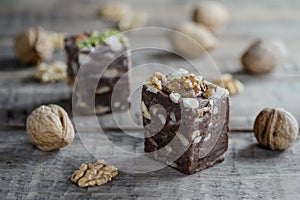 Walnuts and nut halva on a rustic wooden table