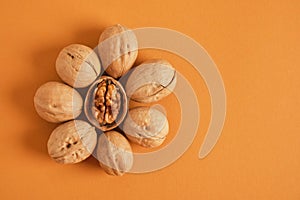 walnuts pattern on brown background, top view copy space