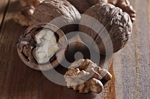 Walnuts peeled and inshell. Brown wooden table. Healthy nutrition, health care, diet. Healthy, fresh and nutritious food. Close-up