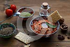 Walnuts and pepper dip sauce Muhammara and ingredients close-up on the table. horizontal