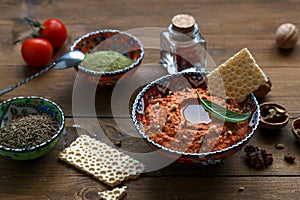 Walnuts and pepper dip sauce Muhammara and ingredients close-up on the table. horizontal