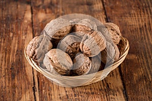 Walnuts pile in bowl on retro wooden table