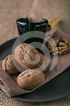 Walnuts on the plate and nutcracker