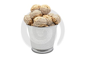 Walnuts in a tin bucket on white background. Wiyh clipping path