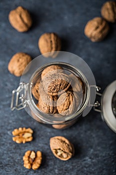 Walnuts. Walnut kernels and whole walnuts on rustic table.