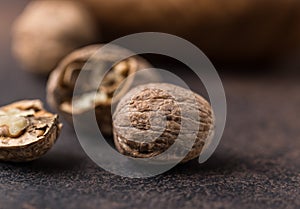 Walnuts. Walnut kernels and whole walnuts on rustic table.