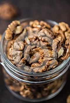 Walnuts. Walnut kernels and whole walnuts on rustic table.