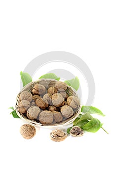 Walnuts with walnut leaves in a basket