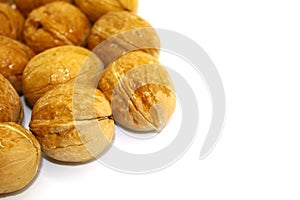 Walnuts, washed with water, placed close-up on a white background