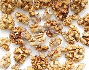 Walnuts on a white background. A pile of peeled dry nuts. Background. Close up.