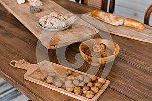 Walnuts on a wooden cutting board in a wooden plate in the kitchen