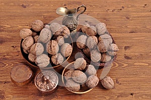 Walnuts in wooden plates on a wooden background