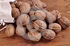 Walnuts in wooden plates on a wooden background