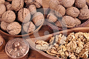 Walnuts in wooden plates on a wooden background