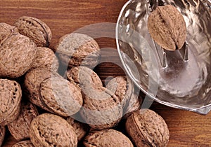 Walnuts in wooden plates on a wooden background