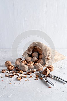 Walnuts are in a yuta bag on a delicate background photo