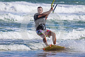 Wan riding kite surf on sea waves