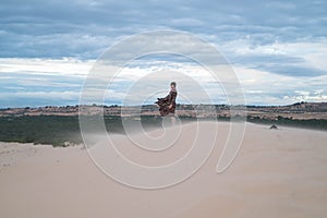 Wanderer walking in the desert. Young man standing in white sand dunes