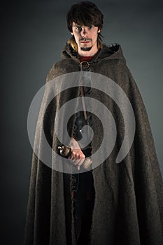 Wandering man in woolen cape with a sword