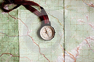 wanderlust and explore concept, compass on map, top view, vintage toned image, space for text