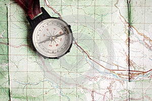 Wanderlust and explore concept, old compass lying on map, top vi