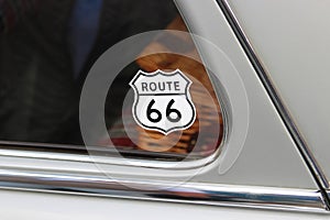 Wanderlust: Route-66-Sticker on the window of an old car