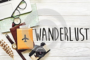 wanderlust and travel concept text, planning summer vacation background flat lay, space for text. map compass photo camera