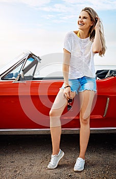 Wanderlust will take you places. a happy young woman enjoying a summers road trip.