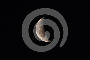 Waning crescent Moon on a dark sky photo