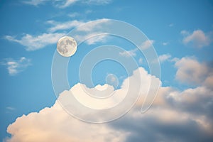 waning gibbous moon through parted clouds