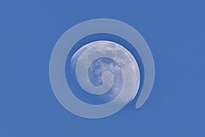 The waning moon with blue sky in march