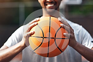 Wanna play one on one. Closeup shot of a sporty young man standing on a basketball court.