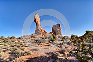 Wanning crescent moon caught in the middle of Skyline Arch photo