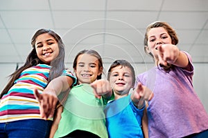 We want to be YOUR friend. Low angle portrait of a diverse group of kids showing pointing towards the camera against a