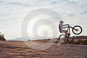 Want to get out of your comfort zone. a young man out mountain biking during the day.