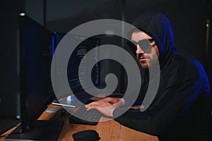 Wanted hackers coding virus ransomware using laptops and computers. Cyber attack, system breaking and malware concept