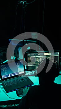 Wanted hackers coding virus ransomware using laptops and computers. Cyber attack, system breaking and malware concept.