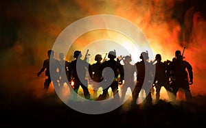 War Concept. Military silhouettes fighting scene on war fog sky background, World War Soldiers Silhouettes Below Cloudy Skyline At