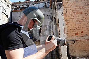 War correspondent photographs destroyed buildings after the bombing