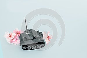 War machine with a flower in the back, peace and war, military action, a flower in the barrel of a tank, free space,