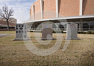 War monuments in the Veterans Memorial Garden with Dallas Memorial Auditorium in the background.