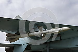 War rocket under the wing of a military jet destroyer