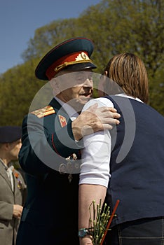 War veteran man portrait. He embraces a woman.