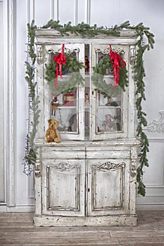 Wardrobe with Christmas toys and Christmas tree garland